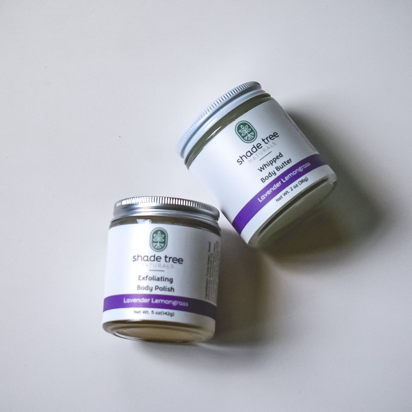 Two jars of 'Shade Tree' exfoliating body polish on a white background