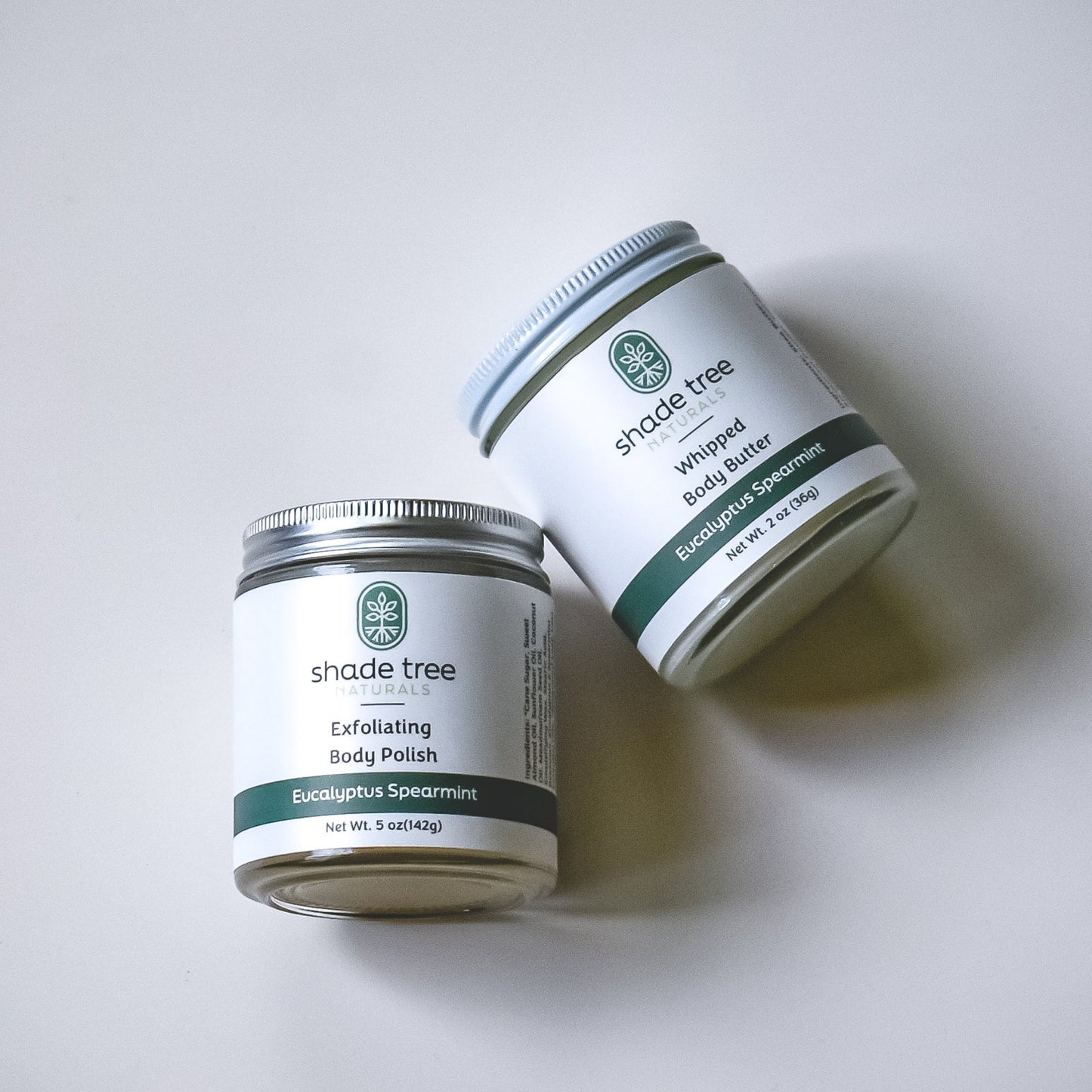 Two jars of 'shade tree' products on a white background