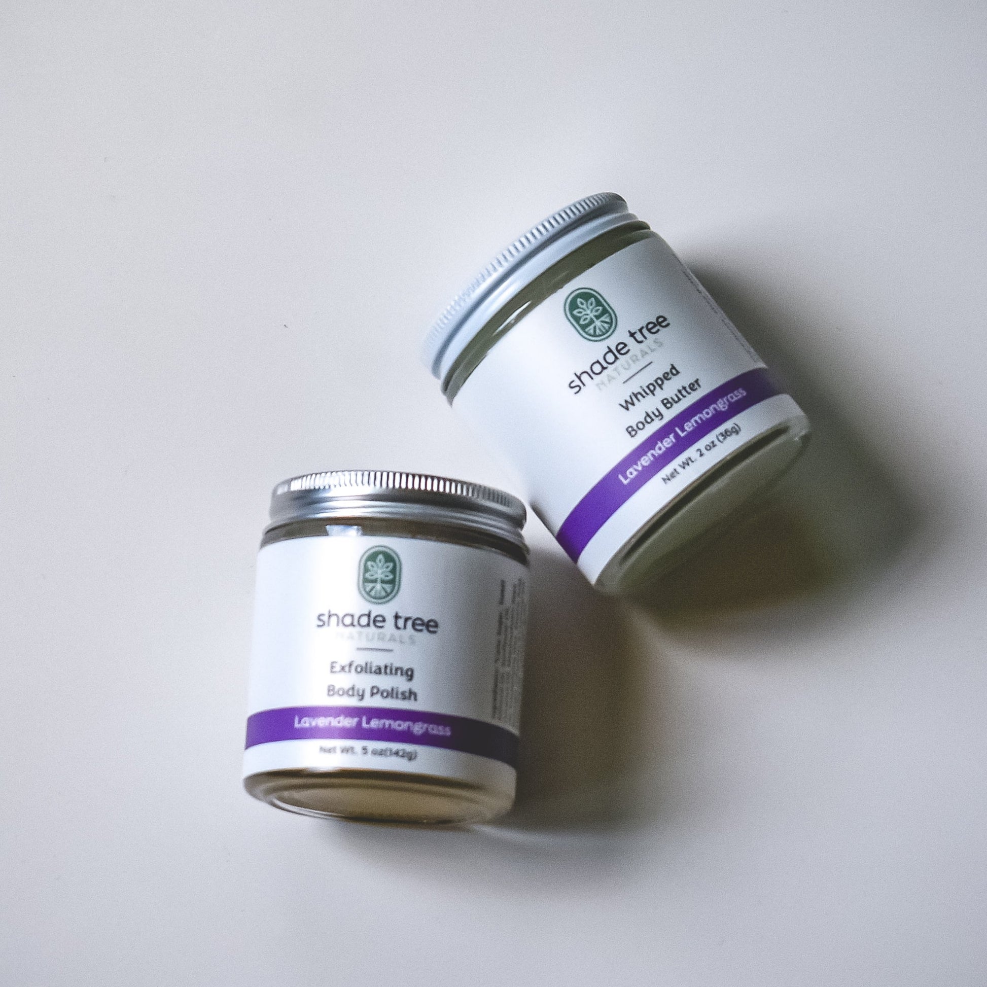 Two jars of 'Shade Tree' exfoliating body polish on a white background