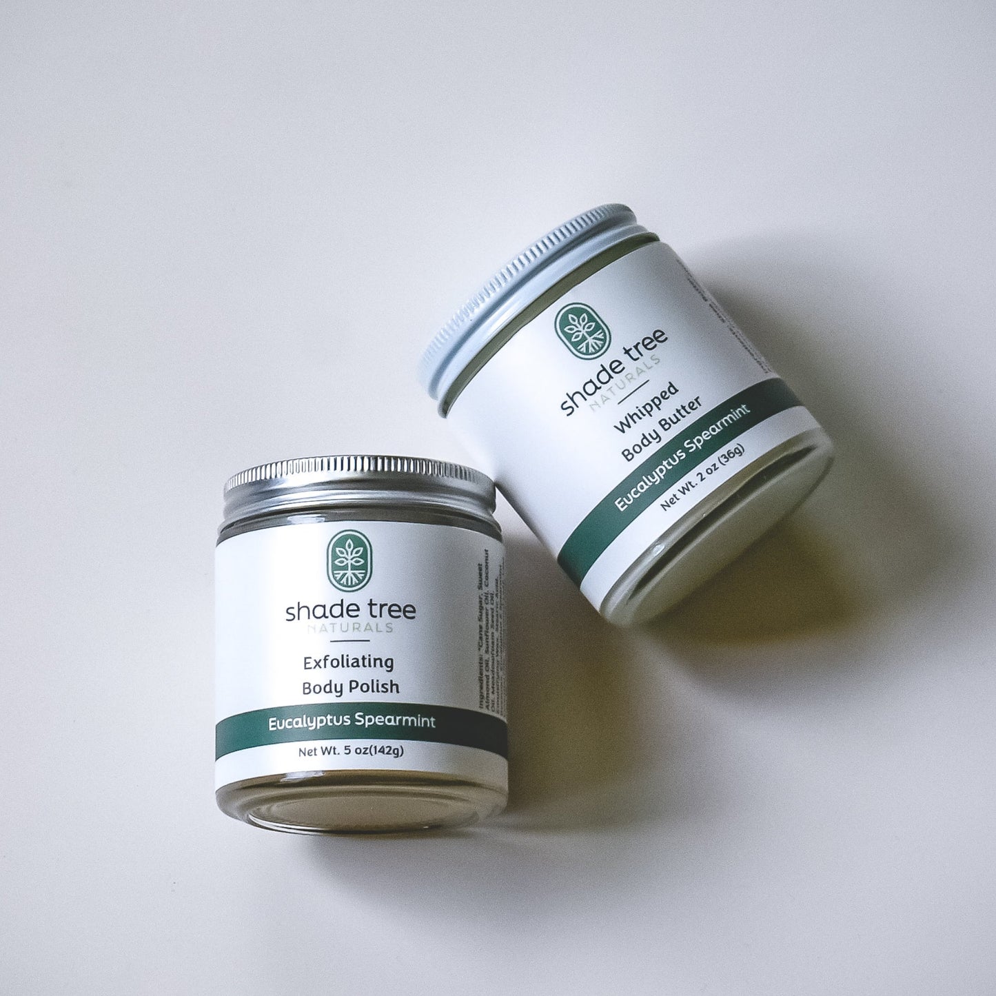 Two jars of 'shade tree' products on a white background