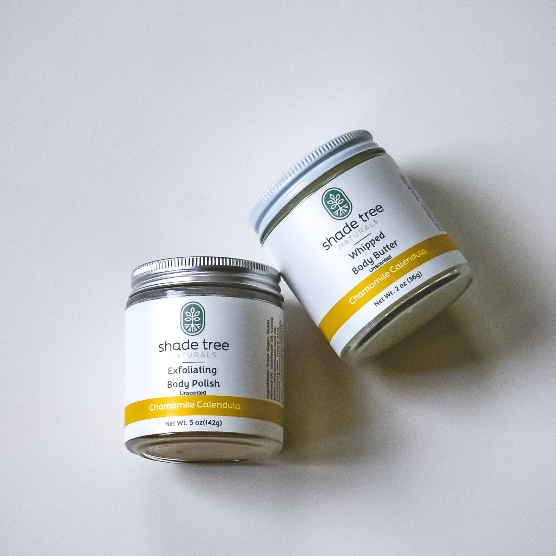 Two jars of Shade Tree body products on a white background