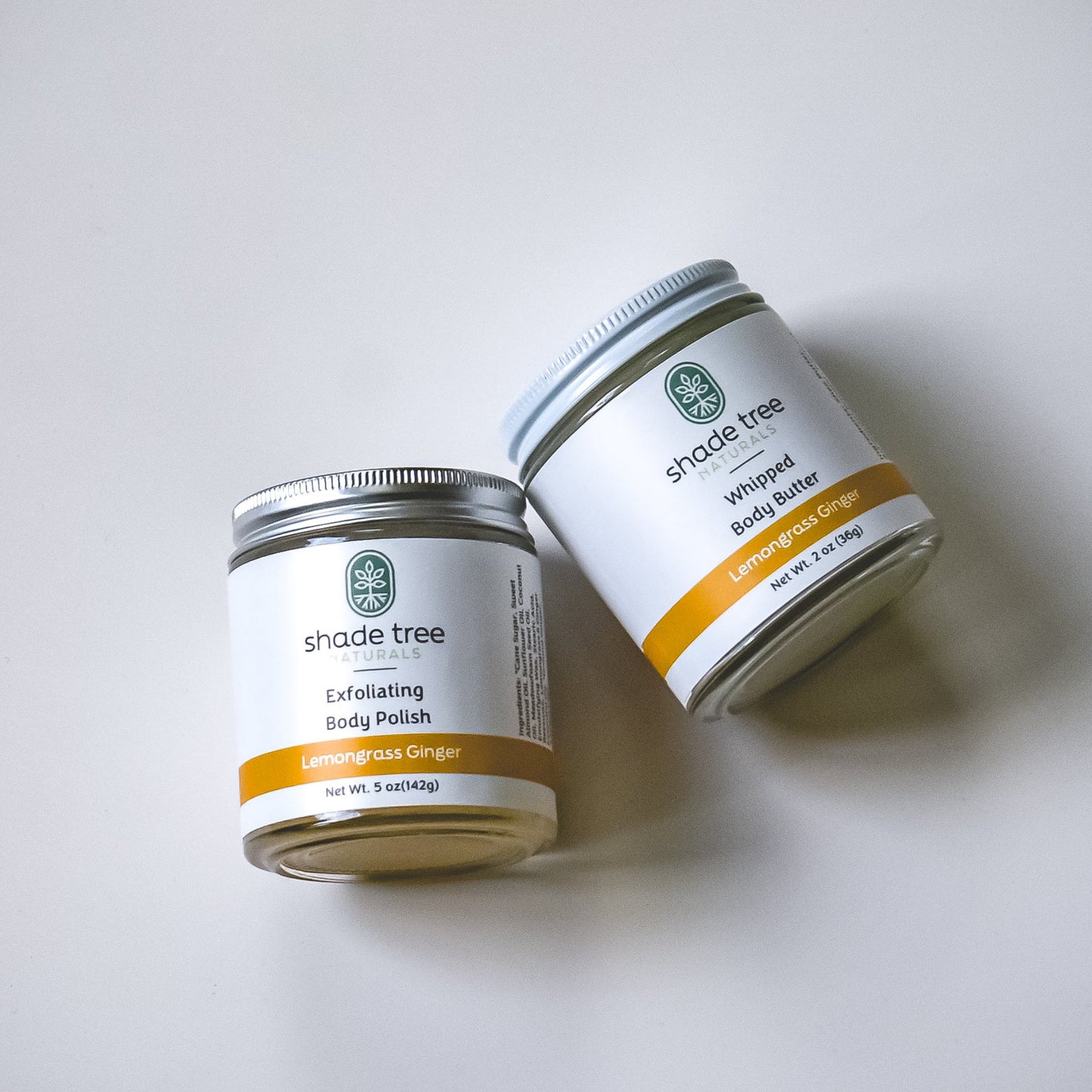 Two jars of Shade Tree body products on a white background