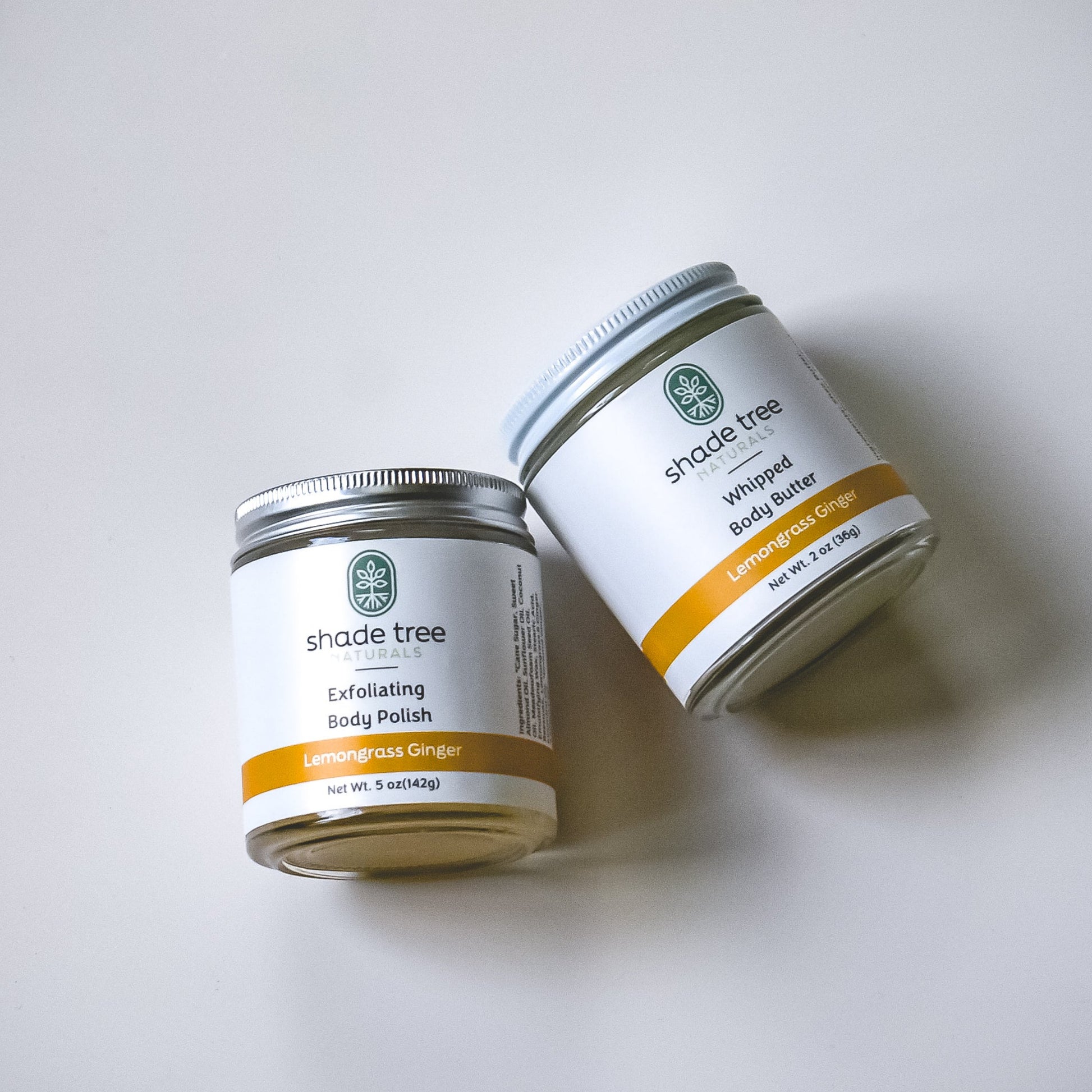 Two jars of Shade Tree body products on a white background