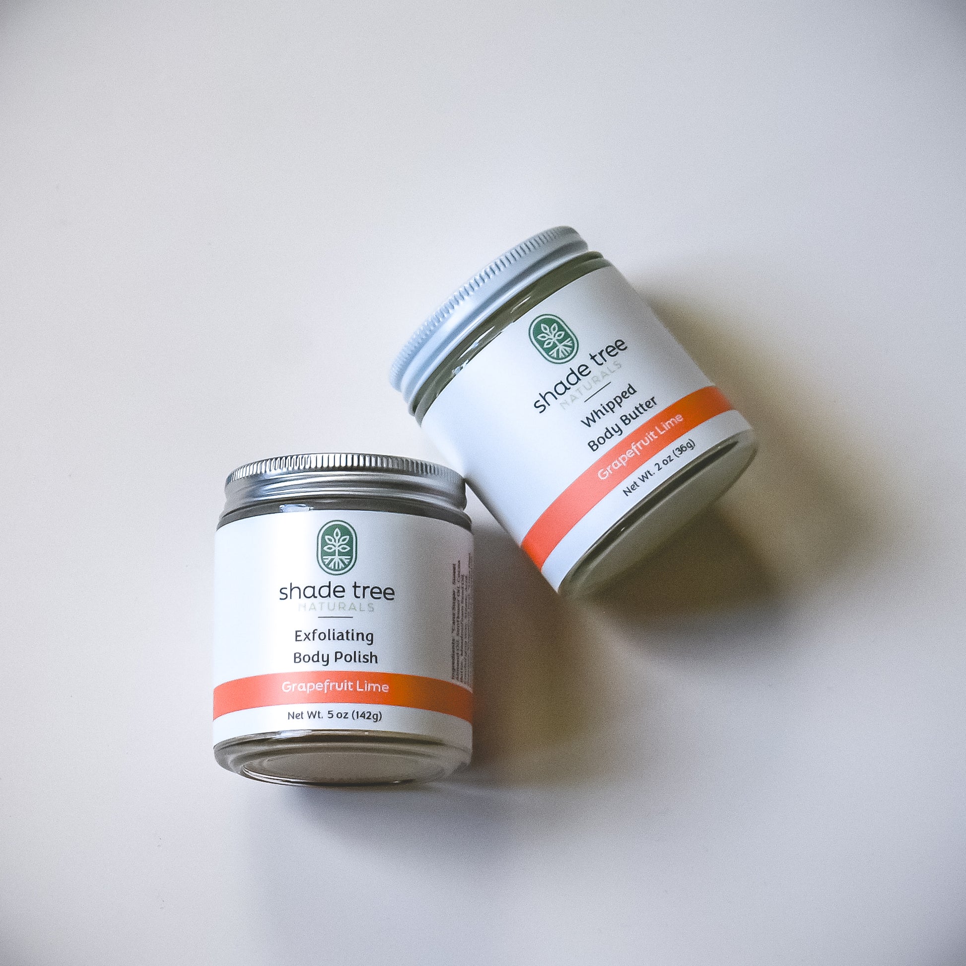 Two jars of Shade Tree body products on a white background